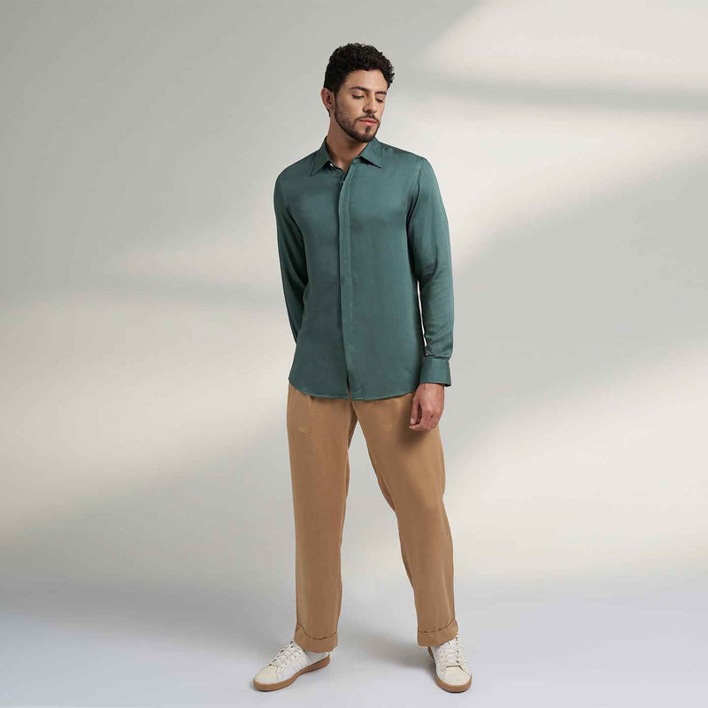 Front view of the solid sage green shirt and khaki trousers