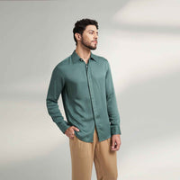 Side view of the solid sage green shirt with khaki trousers
