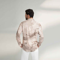 Back view of the blush pink speckled print shirt with white trousers