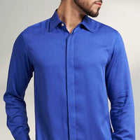 Close-up front view of the solid royal blue shirt collar and placket