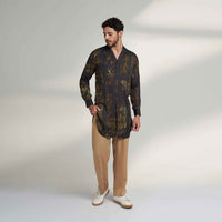 Front view of the longline black and olive printed shirt and khaki trousers