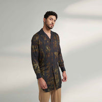 Side view of the longline black and olive printed shirt with khaki trousers