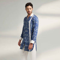 Side view of the longline blue floral print shirt with white contrast collar