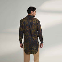 Back view of the longline black and olive printed shirt with khaki trousers