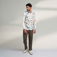 Front view of the white floral print shirt and olive trousers