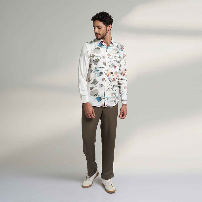 Front view of the white floral print shirt and olive trousers