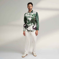 Front view of the sea green and white abstract print shirt and white trousers