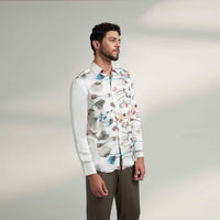 Side view of the white floral print shirt with olive trousers