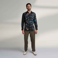 Front view of the black floral print shirt and olive trousers
