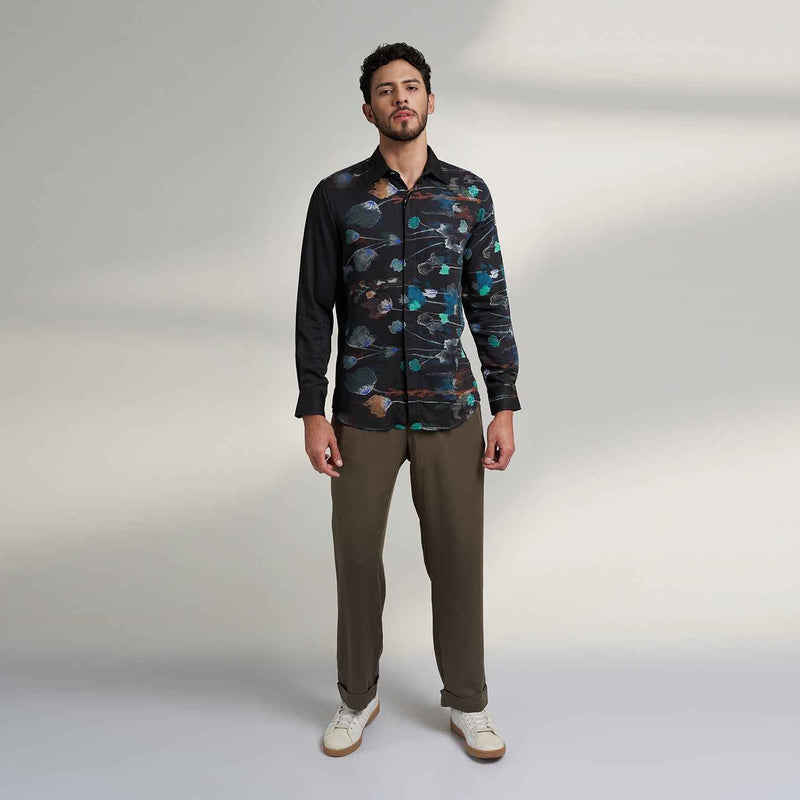 Front view of the black floral print shirt and olive trousers