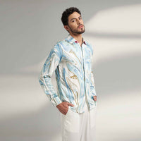 Side view of the blue and white marbled print shirt with white trousers