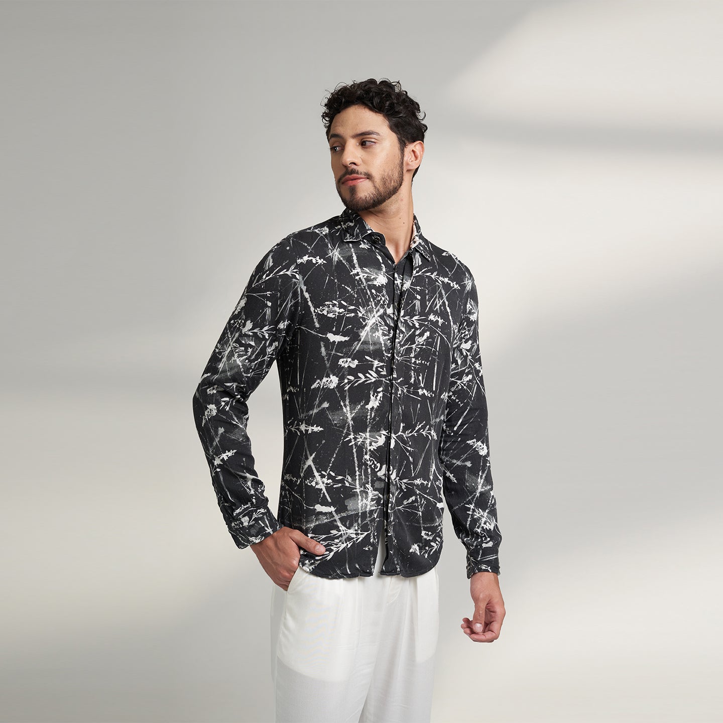 Organic lotus stem fabric printed shirt in black and white leafy print. the shirt has round bottom hem with a comfort fit