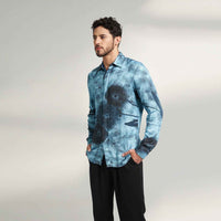Side view of the blue tie-dye print shirt with black trousers