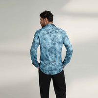 Back view of the blue tie-dye print shirt with black trousers