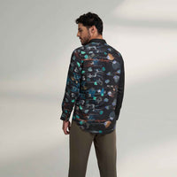 Back view of the black floral print shirt with olive trousers
