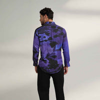 Back view of the purple and black abstract floral print shirt with black trousers