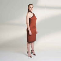 Side view of the maroon fitted midi dress showing the asymmetric neckline