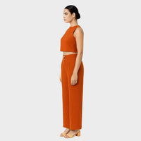 Full-length side view of the burnt orange crop top and wide-leg trousers