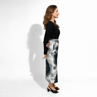 Side profile view of the abstract print culottes paired with a black top