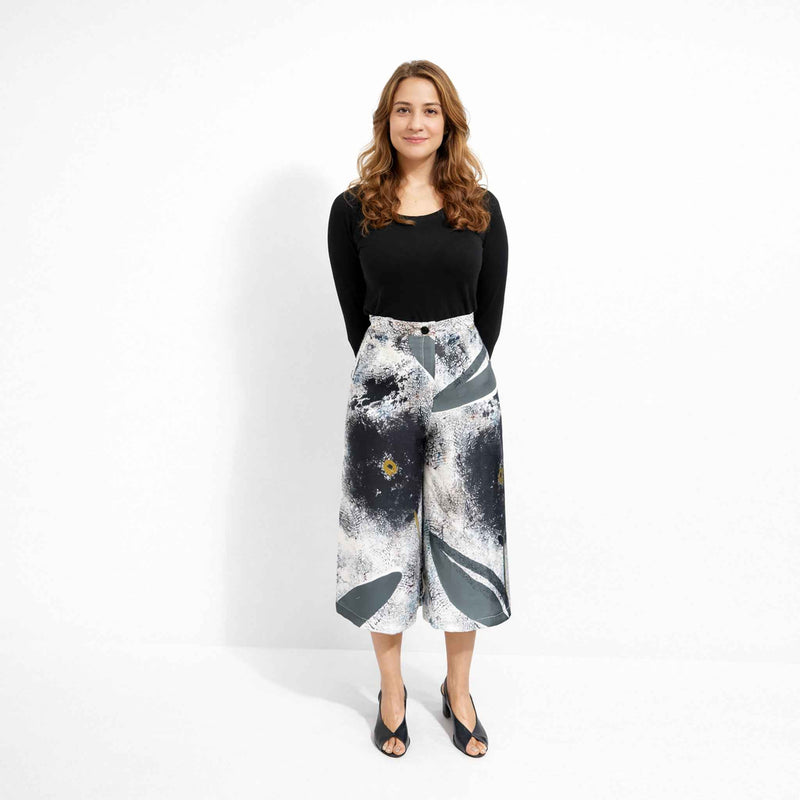 Front view of the abstract grey and black print culottes styled with a black long-sleeve top